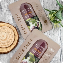 Mascarillas Coreanas de Hoja al mejor precio: Mascarilla Regenerante-Nutritiva Jigott Black Snail Real Ampoule Face Mask de Jigott en Skin Thinks - Piel Seca